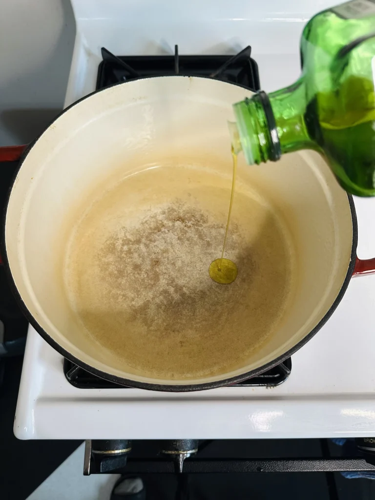 how to make green bean lamb stew, pouring olive oil, olive oil, extra virgina olive oil