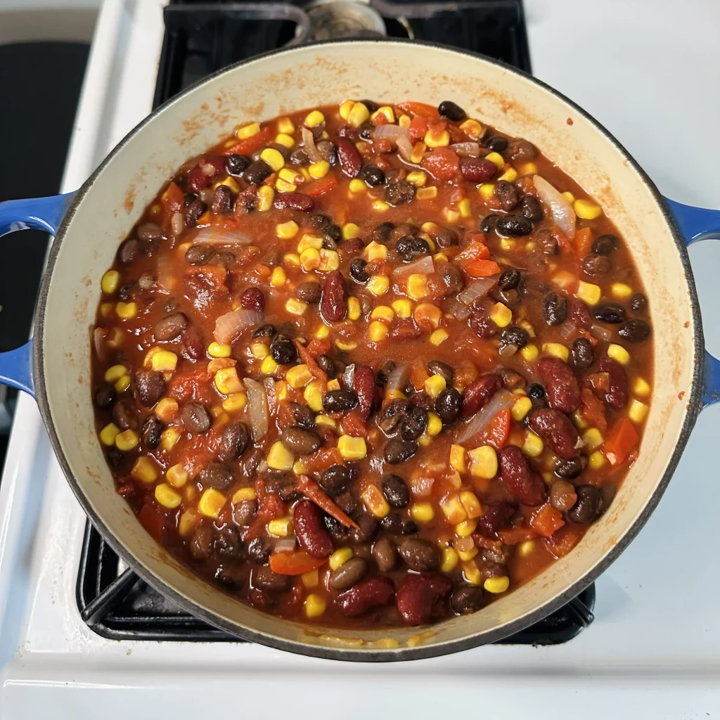 a full 10oz bag of corn mixed into black bean chili with corn on a white oven