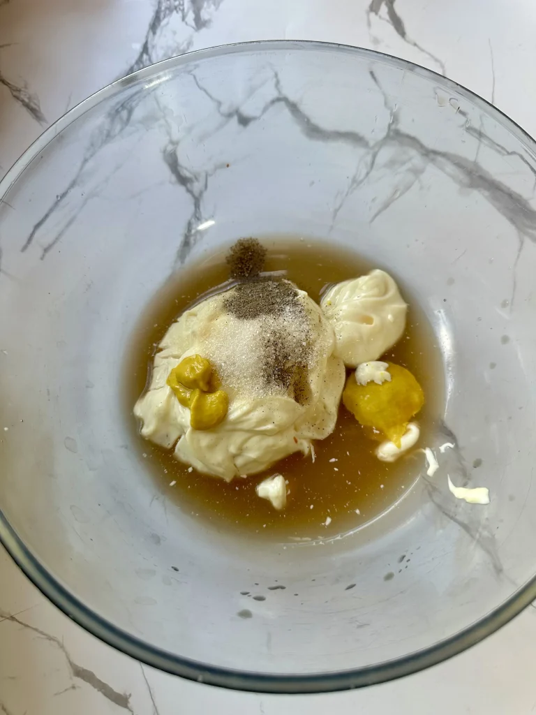 adding all dressing ingredients to a glass bowl