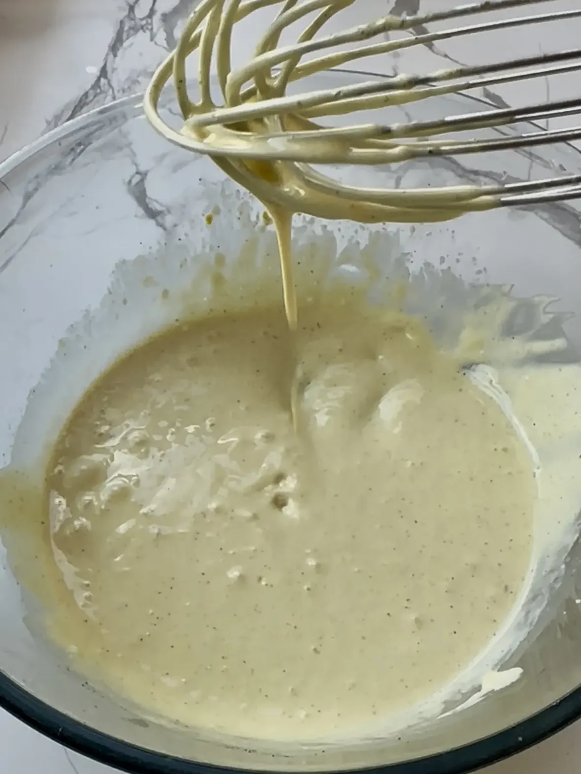 whisking dressing into a smooth liquid