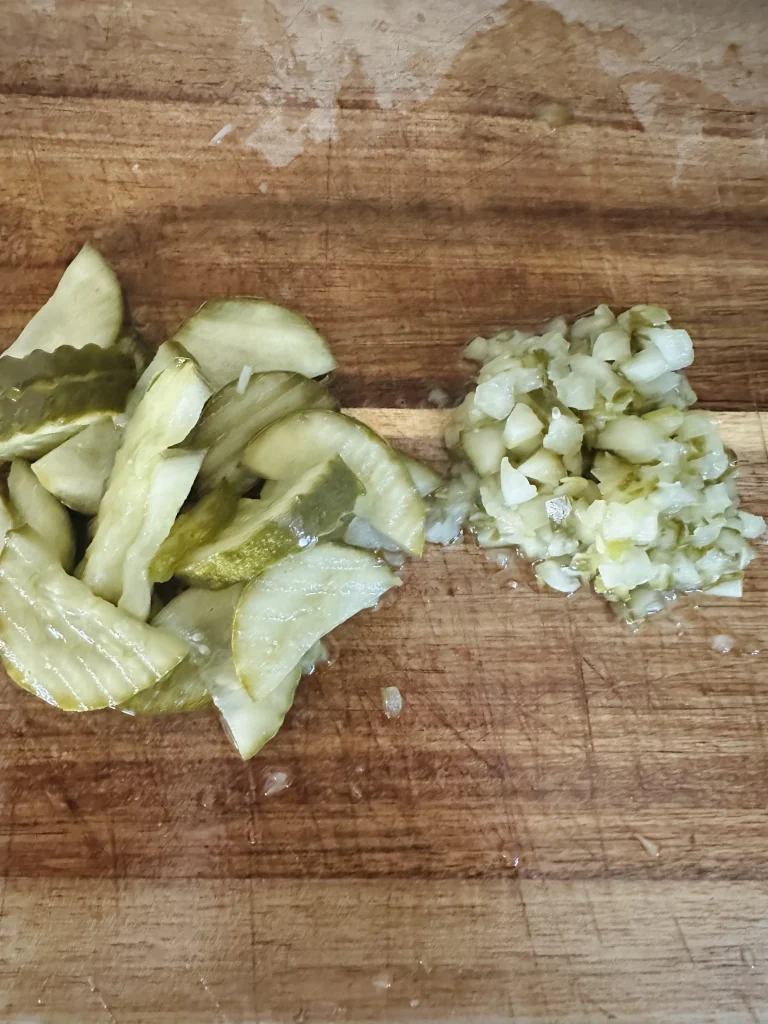 chopped pickles on a cutting board