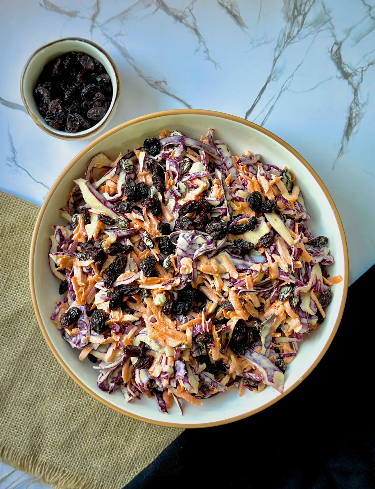 purple cabbage coleslaw on a white plate on a white counter