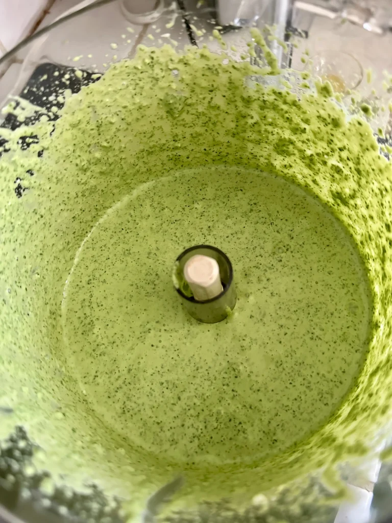 birds eye view of green sauce in food processor