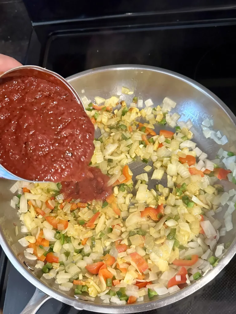 adding tomatoes to pap sauce